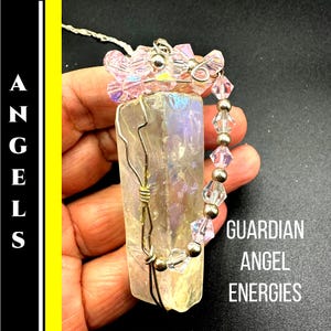 May include: A handmade pendant featuring a rectangular, iridescent crystal wrapped in silver wire. The pendant is adorned with pink crystal beads and the text "GUARDIAN ANGEL ENERGIES". The word "ANGELS" is vertically displayed on the left.