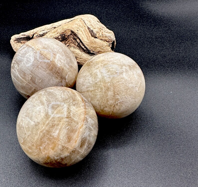 Natural Moonstone Crystal Ball 55-60mm with beautiful shimmer and polished finish. Decorative crystal sphere for home decor, meditation space, sacred altar, spiritual room, office display, crystal collection, birthday gift, Christmas gift, gift for her, gift for witch, gift for crystal lover, and unique gemstone sphere for collectors seeking meaningful and beautiful natural crystal decor.