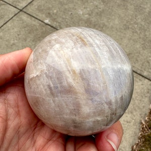 Moonstone Crystal Ball natural moonstone sphere 55-60mm chosen by a Sami Shaman and encoded to Freya. Crystal ball for Reiki practitioners, meditation, yoga, energy healing, intuition development, psychic abilities, spiritual awakening, moon rituals, and chakra balancing. Moonstone sphere associated with inner wisdom, emotional balance, feminine energy, self-discovery, and deeper spiritual connection.