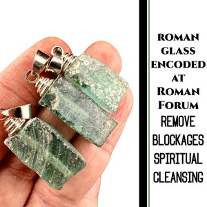 May include: Three green glass pendants with silver wire wrapped around the top. The pendants are rectangular and have a cloudy, textured appearance. The text on the image reads "Roman Glass Encoded at Roman Forum Remove Blockages Spiritual Cleansing".