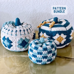 May include: Three crocheted pumpkins in varying sizes and blue, white, and yellow color schemes. The pumpkins feature granny square patterns and textured stitches with small stems. A white rectangular label displays the text PATTERN BUNDLE.