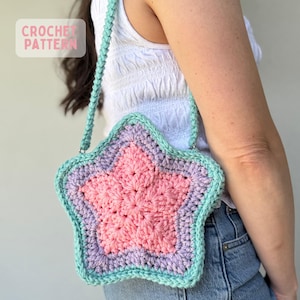 May include: A star-shaped crochet bag featuring a pink center, a light purple middle layer, and a mint green border with a matching mint green strap. The bag has a text overlay in the upper left corner that reads CROCHET PATTERN in pink letters.