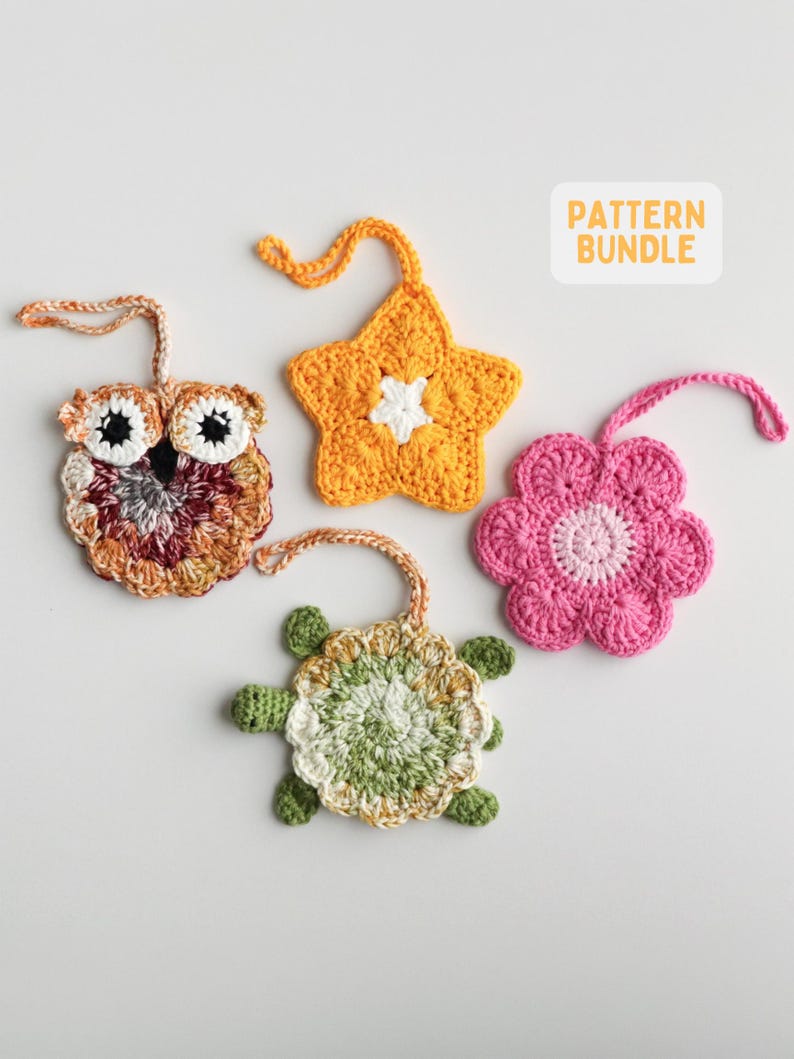 May include: Four crocheted ornaments with hanging loops, including an owl in shades of brown, a yellow star, a green and white turtle, and a pink flower. A white rectangular label in the top right corner displays the text PATTERN BUNDLE.