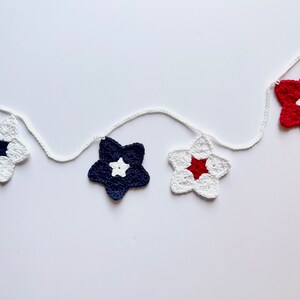 May include: A string of crocheted stars in red, white, and blue, perfect for a patriotic party or home decor.