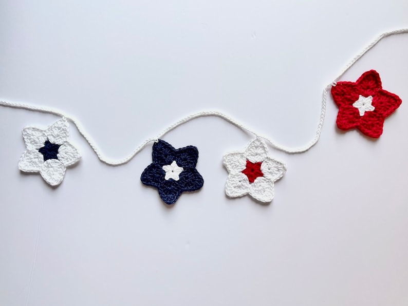May include: A string of crocheted stars in red, white, and blue, perfect for a patriotic party or home decor.