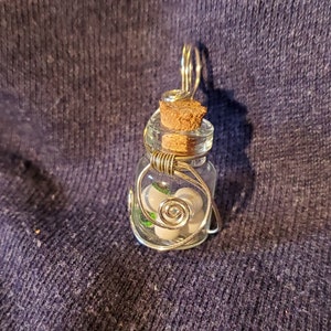 Small glass jar pendant, wire wrapped with tiny eyeballs inside the jar. Eyes are hand painted.