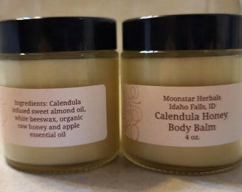 May include: Two glass jars of Calendula Honey Body Balm, a natural skincare product. The jars are labeled with the ingredients and product name. The jars are 4 ounces each.