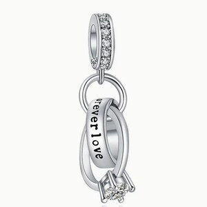 May include: Silver charm with two interlocking rings, one with the inscription "forever love". The rings are adorned with clear cubic zirconia stones.