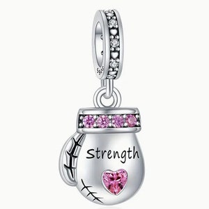 May include: Silver charm in the shape of a boxing glove with pink crystals and the word "Strength" inscribed on it. The charm has a heart-shaped crystal in the center.