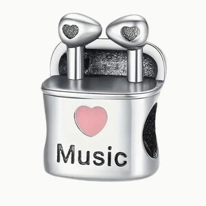 May include: Silver charm with a pink heart and the word "Music" on it. The charm features two silver earbuds with black hearts on them.
