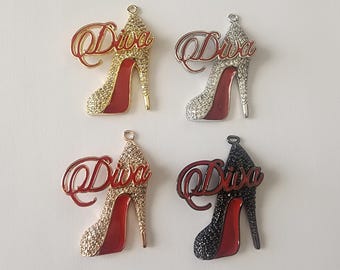 May include: Four high heel shoe charms with the word "Diva" written on them. The charms are in four different colors: gold, silver, black, and red.