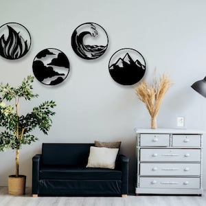May include: Four black metal wall decor pieces in the shape of circles, each depicting a different element: fire, water, air, and earth. The decor is displayed on a white wall with a black couch, a potted plant, a dresser, and a floor lamp.