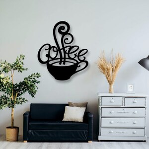 May include: Black metal wall art featuring a coffee cup with steam rising from it and the word "Coffee" written in a stylized font.
