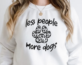 May include: White sweatshirt with a black paw print and the text "less people more dogs".