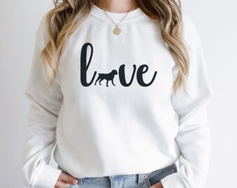 May include: White sweatshirt with the word "love" written in black cursive with a black silhouette of a dog in the middle of the word.