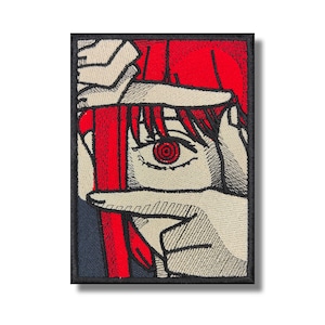 May include: Embroidered patch featuring a close-up of an anime character's eye with a red iris and a black outline. The character's red hair and hands are visible in the background.