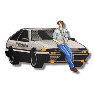 May include: A gray and black embroidered patch of a cartoon character sitting on the hood of a silver car. The car has Japanese text on the side that reads "藤原豆腐店".