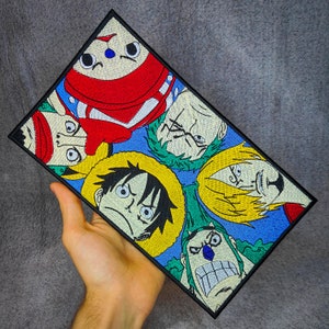 May include: Embroidered patch featuring five anime characters with colourful hair and clothing. The characters are Luffy, Zoro, Sanji, Chopper, and Usopp from the popular anime series One Piece.