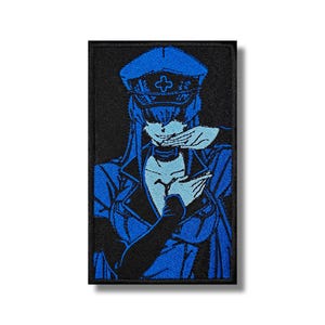 May include: Blue and black embroidered patch of a woman wearing a blue cap with a white cross on it. She is wearing a blue jacket and has her hands crossed in front of her.