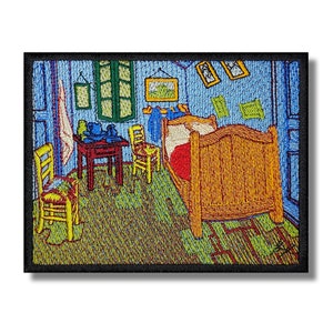 May include: Embroidered patch depicting Vincent van Gogh's famous painting "The Bedroom." The patch features a blue room with a bed, two chairs, a table, and a window. The colors are vibrant and the details are intricate.