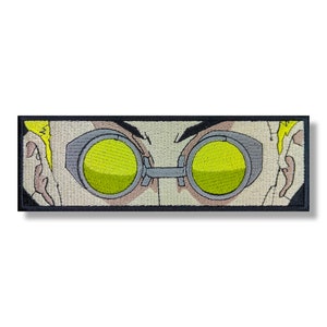 May include: Close-up of a cartoon character's face with yellow goggles. The character has blonde hair and a light brown complexion.