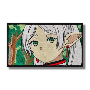 May include: Embroidered patch featuring an anime character with long white hair, green eyes, and pointed ears. The character is wearing a red and white collar and is set against a green background.