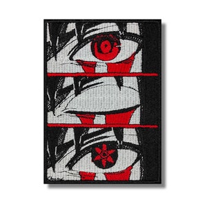 May include: A black and white embroidered patch with three red eyes. The top eye is solid red, the middle eye has a red rim, and the bottom eye has a red rim and a black star in the center.