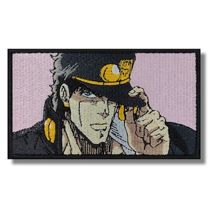 May include: An embroidered patch featuring a man with spiky black hair wearing a black hat with a gold band and a gold star. The man is looking to the right and has a serious expression on his face.