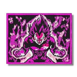 May include: Embroidered patch featuring a stylized illustration of a character with spiky hair and a determined expression. The character is depicted in shades of pink and white against a black background, with a pink border. The patch is rectangular.