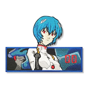 May include: An embroidered patch featuring a blue-haired anime character with red eyes, wearing a white suit. The character is standing in front of a blue and black background with the number "00" in red.
