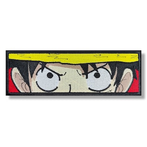Puede incluir: Primer plano de la cara de un personaje de dibujos animados con cabello negro, un sombrero amarillo y ojos grandes y blancos. El personaje tiene una expresión seria.