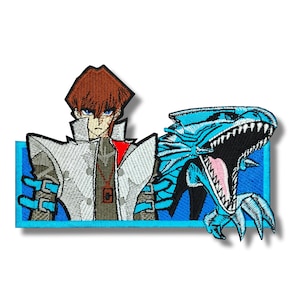 May include: Embroidered patch showing a character with brown hair and a white coat, next to a blue dragon with an open mouth. The patch has a blue rectangular border, designed for application on clothing or accessories.