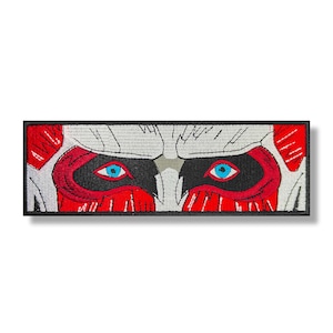 May include: Embroidered patch with a close-up of a face with red and black markings and blue eyes.