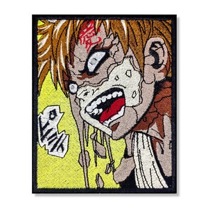 May include: Embroidered patch featuring a close-up of a character's face with a distressed, cracked appearance. The character has spiky, blonde hair and is yelling with a red mouth and white teeth. The background is yellow with a white speech bubble that says "Like".