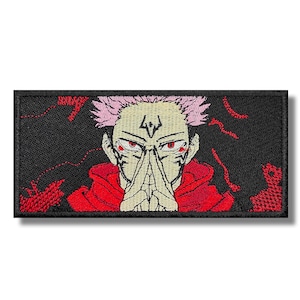 May include: Embroidered patch featuring a character with pink hair, red eyes, and a red hooded cloak. The character has a white symbol on their forehead and is holding their hands together in a prayer position. The background is black with red flames.