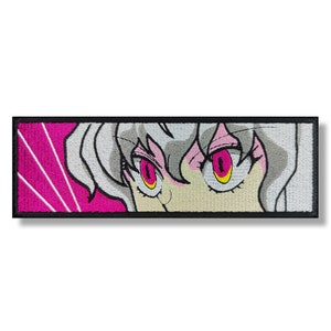 May include: Embroidered patch featuring a close-up of a woman's face with white hair and bright pink eyes. The background is a pink and white striped pattern.