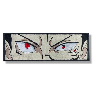 May include: Close-up of a cartoon character's face with red eyes and a serious expression. The character's eyes are wide open and the eyebrows are furrowed. The background is a light beige color.