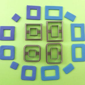 May include: A set of 10 blue and gray plastic cookie cutters in various square and rectangular shapes.
