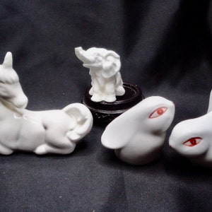 White porcelain UNICORN figurine. Porcelain hand-decorated bunny RABBIT figurines of Chinese manufacture.