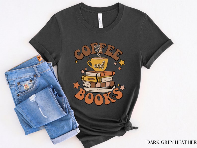 May include: Dark grey heather t-shirt with a retro-style graphic design featuring a coffee cup and books with the text "Coffee and Books".