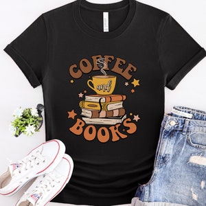 May include: Black t-shirt with a graphic design of a coffee cup and books with the text "Coffee and Books" in a retro style.