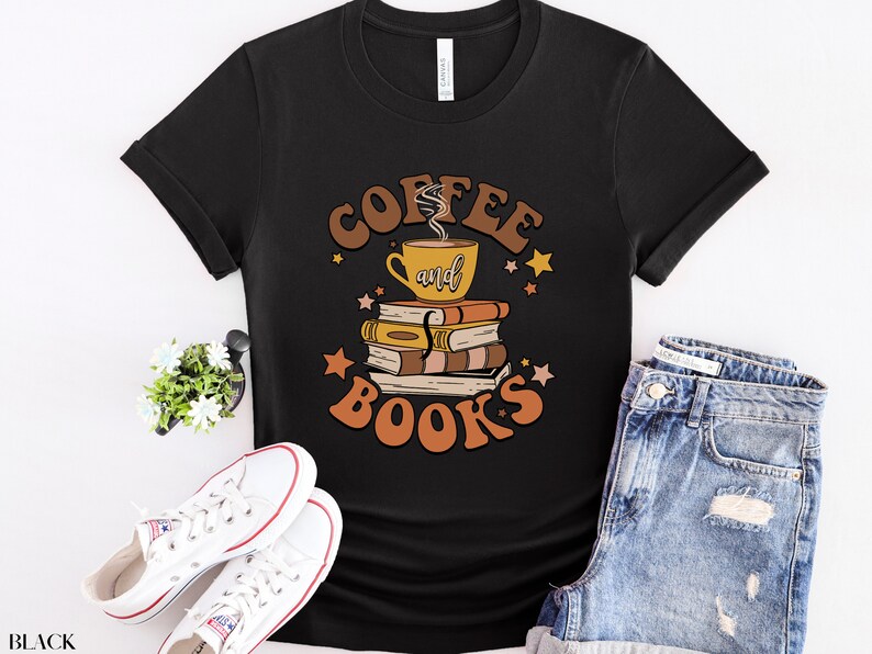 May include: Black t-shirt with a graphic design of a coffee cup and books with the text "Coffee and Books" in a retro style.