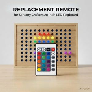 May include: A replacement remote for a Sensory Crafters 28-inch LED pegboard. The remote has multiple color buttons and function buttons. The pegboard is made of wood and has colored pegs inserted. The text "REPLACEMENT REMOTE" is at the top.