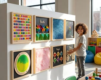 May include: A display of sensory boards with wooden frames. The boards feature various textures and interactive elements, including colorful blocks, pinwheels, and gears. A child stands near the boards, interacting with the gears.