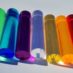 May include: A set of ten round acrylic rods in various colours, including green, blue, purple, clear, yellow, orange, red, and pink. The rods are arranged in a rainbow pattern.