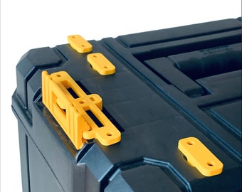 May include: Black toolbox with yellow latches and a yellow handle. The toolbox has a textured surface.