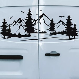 May include: Black and white silhouette decal of a mountain range with trees and birds on a white van door.