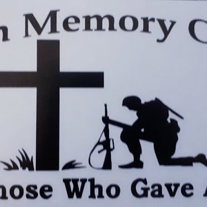 May include: Black and white silhouette of a soldier kneeling in prayer next to a cross. The text "In Memory Of Those Who Gave All" is below the image.