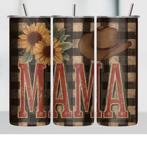 May include: Three stainless steel tumblers with lids and straws. Each tumbler features a design with the word "MAMA" in red letters, a brown cowboy hat, and sunflowers against a black and tan plaid background. The tumblers are designed for cold beverages.