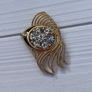Vintage Gold tone fish brooch with clear crystal.